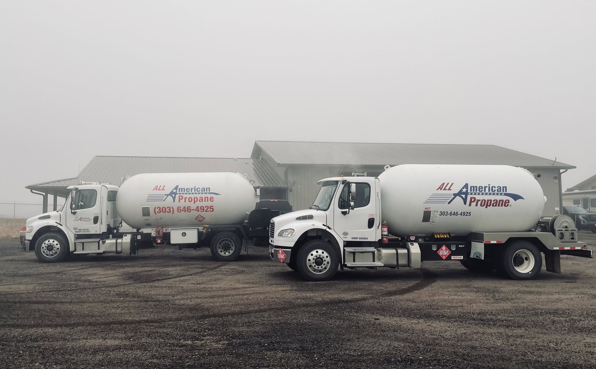 2 propane trucks in front of a building